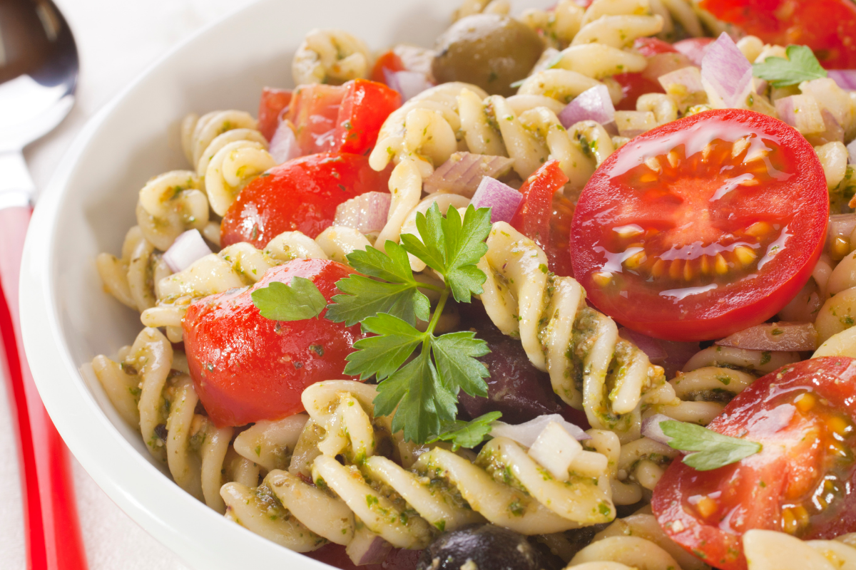 fusilli pasta salad in white bowl