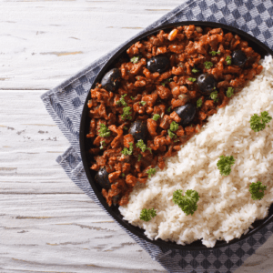 a plate of rice and Brazilian picadillo with olives