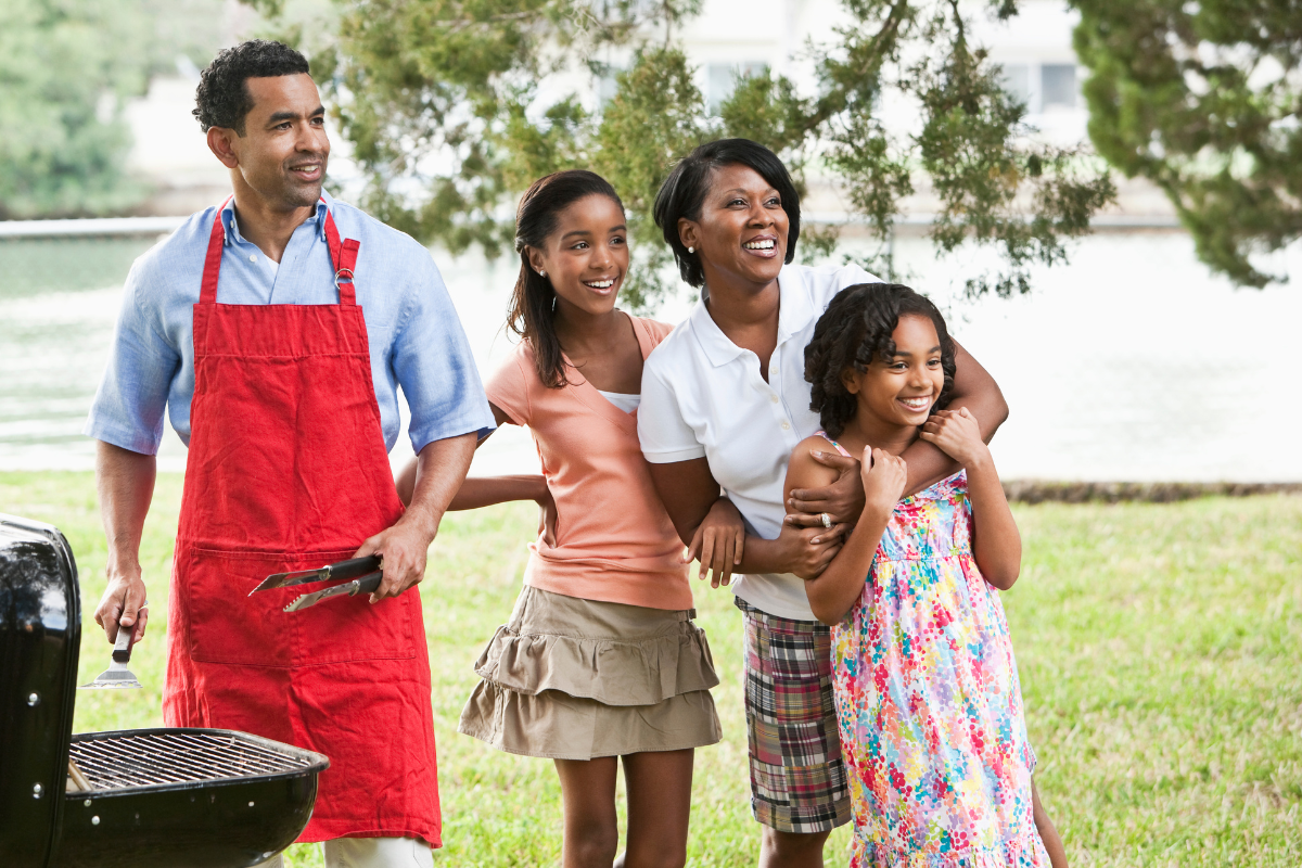 Family around grill for cookout