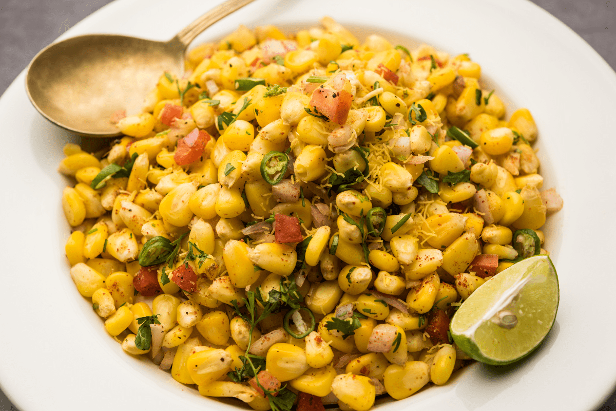 grilled corn salad with a lime wedge garnish