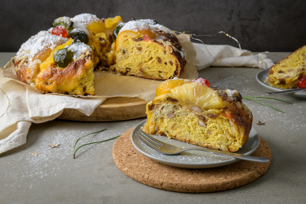 bolo rei with one slice on a plate in front